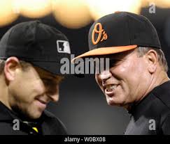 Baltimore Orioles manager Dave Trembley argues with second base umpire Laz  Diaz (L), third base umpire Wally Bell (C) and first bast umpire Bill Welke  (R) after pitcher Daniel Cabrera was ejected