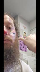 A clown with a cow pooping