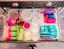 The clear glass jars make it easy to stay organized, while the swivel base makes everything accessible. Organize Your Kitchen With These 6 Dollar Store Items The Diy Mommy Organize Plastic Containers Dollar Store Diy Organization Tupperware Organizing