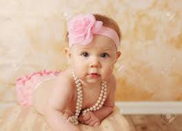 Adorable Young Baby Girl Wearing A Vintage Pearl Necklace And Pink Rose Headband Stock Photo Picture And Royalty Free Image Image 9939693