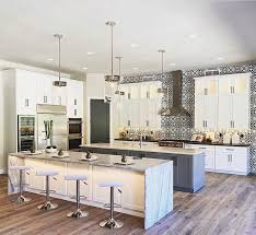 This double island kitchen design has a second center island has a distressed grayish black finish with smaller crown molding supporting a jet black polished granite countertop. Double Island Kitchen In 2021 Kitchen Design Kitchen Inspirations Kitchen Renovation