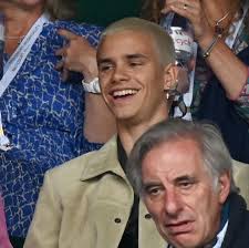 Romeo Beckham with girlfriend Mia Regan in the stands