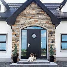 Brown quartzite stone porch with arch detail built on keystone lintel. Front Doors On Instagram Modern Front Porches Front Porch Stone Front Porch Design