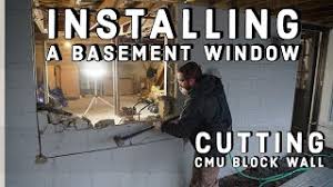 A huge water cooled cutting saw attaches to each rail and is slowly moved up and down the rails. Installing A Basement Window Cutting Concrete Block Foundation Youtube