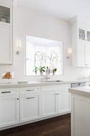 As an aside our kitchen gets minimal natural lighting so. White Glazed Brick Tiles With Light Gray Quartz Countertops Transitional Kitchen