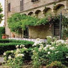 A Vine Covered Arbor Shades A Dining Table In A Tuscan Garden Tuscan Garden Garden Outdoor Inspirations