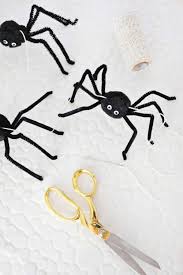 For this eerie project, you need wool yarn, scissors and tape. Easy Spider Garland Diy A Beautiful Mess