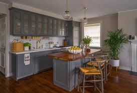 Kitchen flooring type includes laminate, vinyl, hardwood, porcelain tile, slate tile, limestone, concrete, and cork, and all options come in a variety of colors. Curved Wood Countertop On Charcoal Gray Center Island Transitional Kitchen