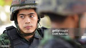 A Thai army officer briefs soldiers standing guard outside the... News  Photo