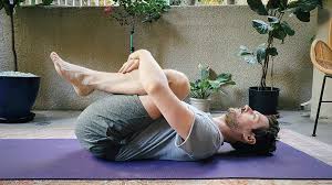 Beginner yoga pose, child's pose on mat