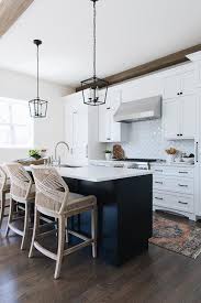 Multi dimensional functionality makes silestone natural quartz countertops a multi dimensional functionality makes silestone natural quartz the quartz counter on the island is a deep black with white veins. Black Lanterns Over Black Island With White Quartz Top Transitional Kitchen