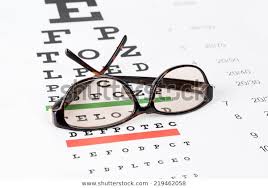 Prescription Sunglasses On Eye Chart Background Stock Photo
