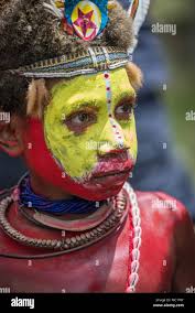 A young Huli boy with red and yellow face painting, Mount Hagen Cultural  Show, Papua New Guinea Stock Photo