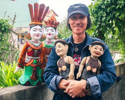 The hands of a Cambodian artisan carefully crafting a traditional doll