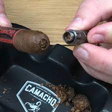You press the cigar punch into the end of your cigar, and when you remove it, you have punched a circular hole in cigar, ready to smoke it. How To Properly Cut A Cigar Best Cutting Techniques For A Perfect Draw
