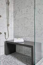 Contemporary Bathroom Shower Is Filled With White Grid Marble Tiles Lined With A Freestanding Gray Quartz W Shower Remodel Bathroom Remodel Shower Shower Bench