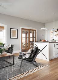 A portion of a metal windmill fan and a metal letter sign serve as art pieces and the room is staged with bright, comfortable furniture, as seen on. 190 Living Rooms Ideas In 2021 Fixer Upper Home Home Decor