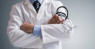 Happy doctor talking to senior male patient while being in a home visit. Police Arrest Suspect For Posing As Doctor To Give Breast Exams The Times Of Israel