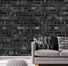 Attractive businesswoman in coat and glasses smiling and holding book. Wallpaper Mural Old Black Bricks Wall Mural Texture Wall Mural Muralunique Com Muralunique