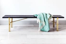 The sturdy, solid rubberwood table features an open box frame with a bottom center support design, a rectangular top with rounded edges, and an apron. Square Peg Table And Bench Adam Blencowe