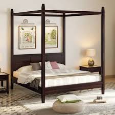 Looks solid black from afar, but closer inspection reveals looks solid black from afar, but closer inspection reveals the wood's gorgeous grain and texture. Malabar Four Poster Bed Solid Wood Urban Ladder