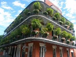 At night, bourbon street is lit by neon lights, loud music and decorated with beads. New Orleans Famous Wrought Iron Railings On Bourbon Street Iron Railing Wrought Iron Railing Wrought Iron