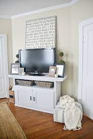 Placing an oversized tv on a stand that is the same size or smaller. How To Decorate Around A Tv Liz Marie Blog