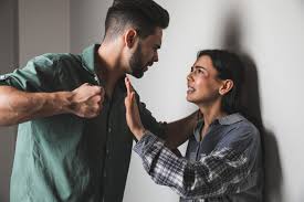 The man comes to hit his wife while she begs him not to do it.