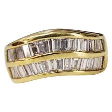 Capture her heart with the royal look of this diamond engagement ring. 14 Karat Yellow Gold 4 Row Baguette Cut Channel Ring At 1stdibs