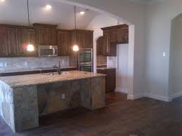 Dark Walnut Stained Knotty Alder Cabinets Travertine Backsplash Santa Cecilia Granite Arkansas Concrete Stained Floors Knotty Alder Cabinets Alder Cabinets