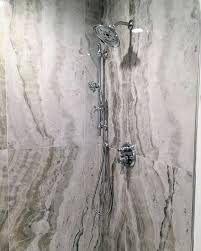 Find ideas and inspiration for 24x48 tile bathroom we moved the tub, shower and toilet to different locations to make the bathroom look more organized. 24x48 Onyx Look Porcelain Large Format Tile Shower Shower Tile Shower Wall Tile Onyx Shower