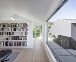 The new construction includes a kitchen and family living area, a master bedroom suite, and a fourth floor dormer expansion. Old Bungalow Transformed Into Award Winning Home With A Modern Extension