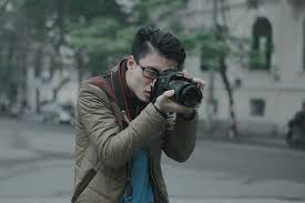 Maybe you would like to learn more about one of these? Person Shallow Focus Photography Of Man Taking Photograph Holding His Camera Photographer Image Free Stock Photo