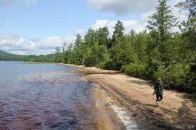 There's a 1/2 mile trail down to a picnic and beach area from the parking. Ampersand Beach Middle Saranac Lake See Swim