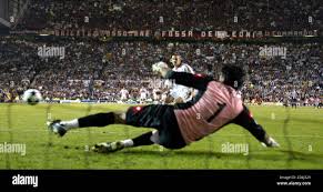 AC Milan's Ukrainian striker Andriy Shevchenko scores the winning penalty  against Juventus'Gianluigi Buffon during their penalty shoot out in the  Champions League final at Old Trafford in Manchester, May 28, 2003.  REUTERS/Alessandro