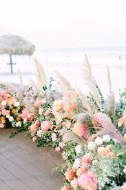 Semi Circle Garden For Beach Side Wedding Ceremony Is Filled With Coral Charm Peonies Blush R Grass Wedding Wedding Ceremony Seating Circle Wedding Ceremonies