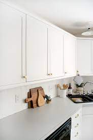Flat front laminate cabinet doors are so plain and basic. How To Add Trim And Paint Your Laminate Cabinets Brepurposed