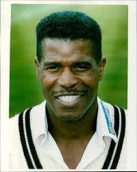 Surrey Cricket Club's Joey Benjamin takes a swing in a match.