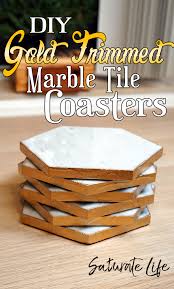 The first thing you'll want to do is tape off your tiles in the design that you want. Diy Marble Tile Coasters With Gold Trim Saturate Life