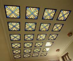 White gypsum board is designed with thin, vertical cuts to reveal brightly lit bulbs inside. Glass Ceiling Design Pictures