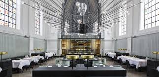 Selective focus of glasses near tissues and modern restaurant interior in night illumination, pattaya, thail. Modern Restaurants With Inspiring Design You Should Visit