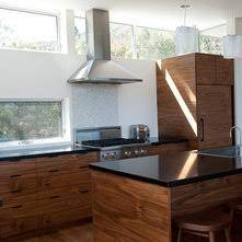 The very modern look of a kitchen with its white shaker cabinets. Countertops With Black Walnut Cabinets