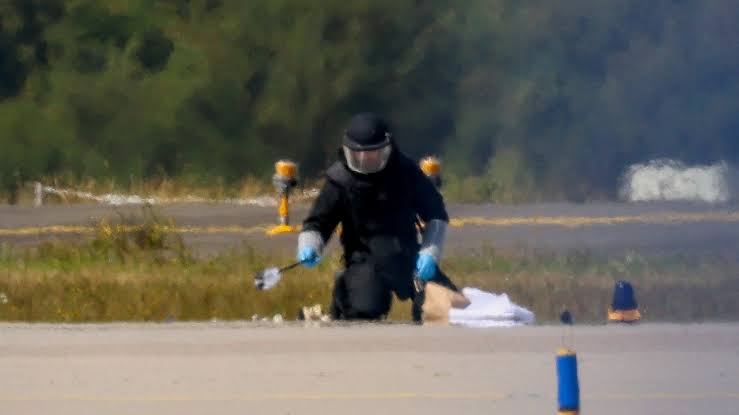 Security personnel and investigators cordoning off the area near the Leipzig/Halle Airport drone landing site.