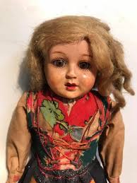 Can someone help me identify this beauty? No markings anywhere, top of her  head feels hollow. She is 15.5 inches long and filled w sawdust.