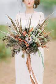 Roses, orchids, ferns and peacock feathers. 74 Dreamy And Relaxed Bohemian Wedding Bouquets Weddingomania