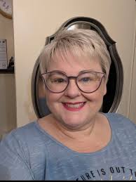 Hi. Can someone help me by making the background of this photo a dark tan  and changing the color.of.my shirt to a solid blue or something? Need it  for professional image. Pleaseeeee |