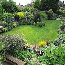 This Town Garden Has A Serpentine Shaped Law Borders Trees Patio And Water Feature Garden Garden Cottage Garden Design Garden Design Layout Garden Layout