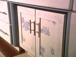Paint pyramids hold cabinet doors in place to make staining easier. An Inexpensive Way To Update Kitchen Cabinets Hgtv