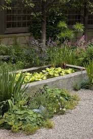 A Shallow Formal Pond Is Softened By Informal Planting Into The Surrounding Gravel Water Features In The Garden Ponds Backyard Small Garden