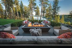 Round grate style fire pit on concrete slab patio with curved would bench seating. Where The Livin Is Easy Mountain Living